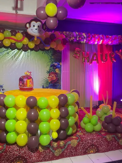 I love bringing kids' favorite themes to life. This is a fun Jungle theme setup with a cake table wrapped in green and brown balloons, an arch with a monkey foil balloon, and a backdrop featuring friendly jungle animals.
