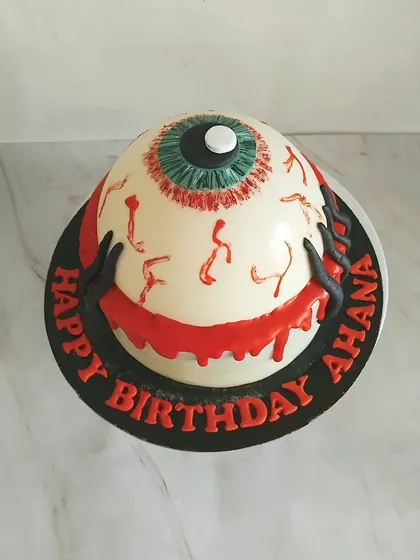 A spooky Halloween themed birthday cake. This monster eyeball design is perfect for someone who enjoys a bit of horror with their celebration.