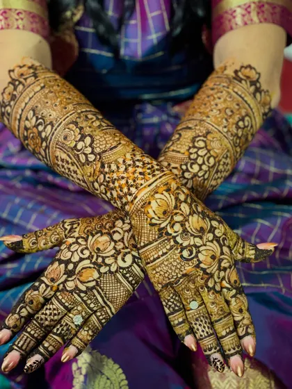 Another angle of the traditional bridal hands, highlighting the rich stain and the detailed work on the fingers.