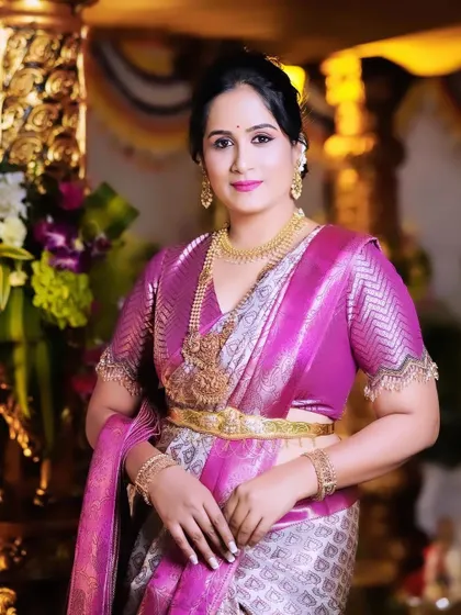 Hemalatha looking regal and poised. The rich pink of the saree and the intricate silver weaving create a truly festive look.