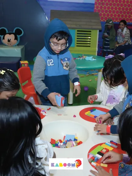 A group of children huddles around our Lego and building block table, completely absorbed in creating their own worlds. It's a space for quiet focus and endless imagination.