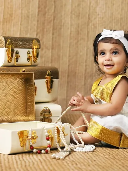 This ten-month-old is exploring a treasure chest of pearls. I love creating setups that encourage babies to interact and show off their curious personalities.