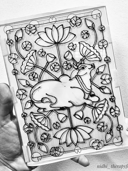 The line work for the Pichwai-style cow on glass, surrounded by lotus flowers and buds.