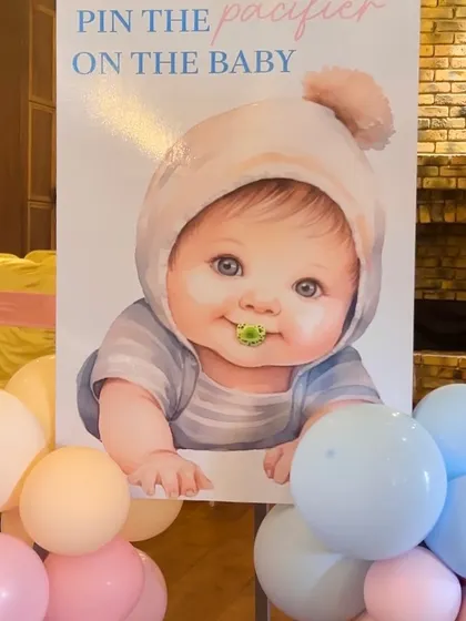 "Pin the Pacifier on the Baby" is a classic game that we can customize with a cute poster and themed setup.