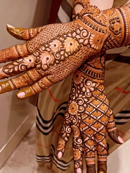 The back of the hands deserve just as much detail. This design features a mix of delicate dot work and bold floral patterns.