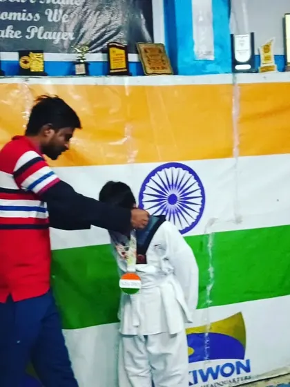 Awarding a medal to a young champion at our academy.