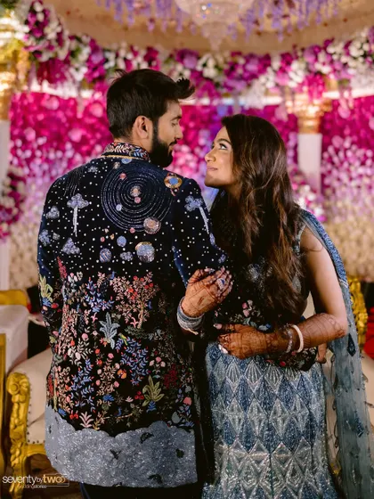 A candid moment between the couple. The bride's makeup is flawless, enhancing her natural beauty and creating a radiant glow.