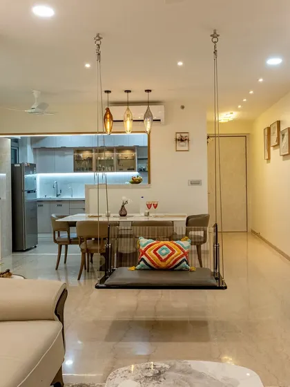 This living room features a cozy swing, an open-concept layout connecting to the kitchen, and breathtaking 35th-floor views from the large windows.