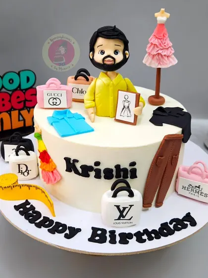 A cake for a fashion stylist, surrounded by all his favorite luxury brands and tools of the trade.