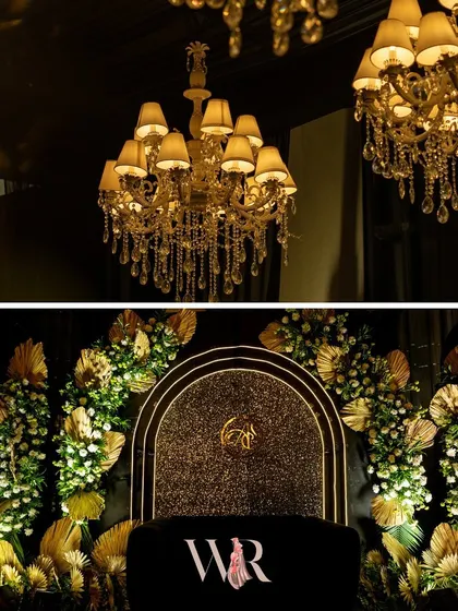 A closer look at the stage for the Jazz Club night. The backdrop is a shimmering gold, framed by an arch of white florals and golden leaves, with a black velvet seat for the couple.