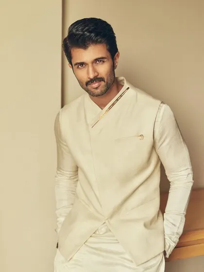 A portrait of Vijay, highlighting the clean lines and subtle metallic details on the collar of his waistcoat.