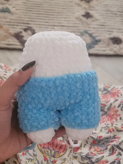 A progress shot showing the bottom half of the Fluffy bunny, with the blue overalls attached to the white body.