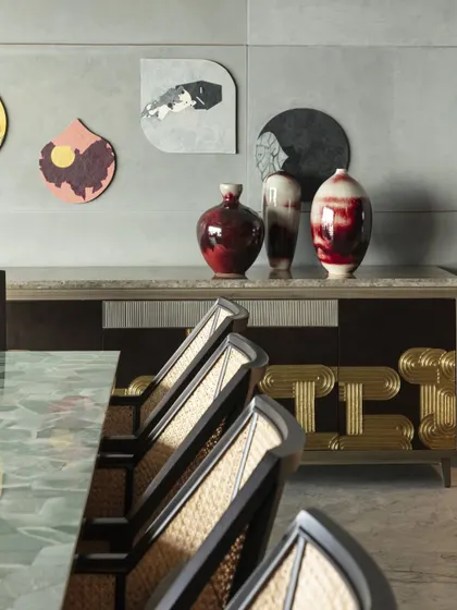 The custom sideboard with Thathera metalwork is paired with vibrant red ceramic vases by Zikwa. The composition is a testament to our focus on combining traditional crafts with contemporary forms.