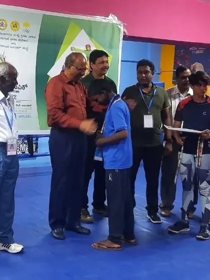 A proud moment for one of our boxers as he receives his medal at the Mini Olympics. Seeing their hard work pay off is the best part of being a coach.