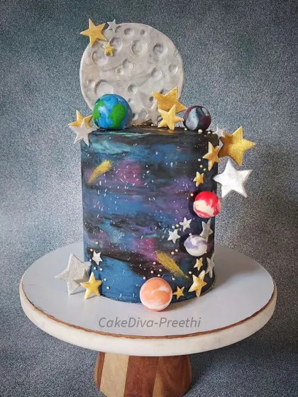I love creating tall, dramatic cakes, and this 12-inch double-barrel galaxy cake was a fantastic challenge. I hand-painted the galaxy effect onto white chocolate ganache and adorned it with a fondant moon, planets, and shimmering stars to create a cosmic masterpiece.
