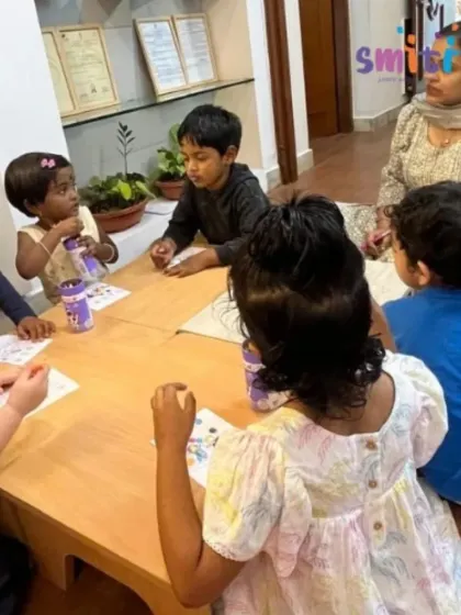 A teacher sits with a group of children during an art session for Eid. Our teachers guide and support the children, creating a warm and encouraging atmosphere for learning.