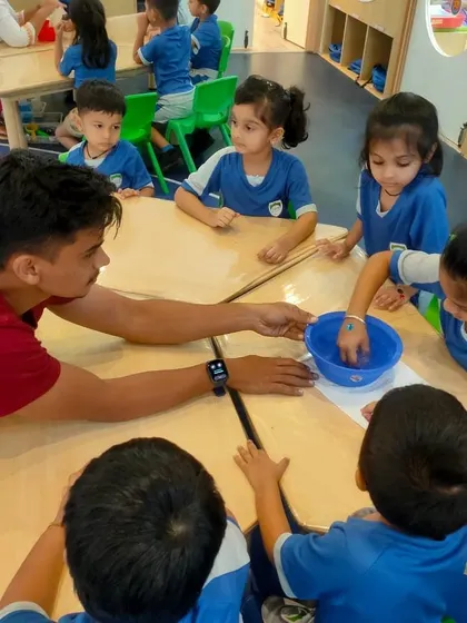 A small group of kindergarteners learns about habitats with one of our instructors. We use simple materials to explain complex topics in an age-appropriate manner.