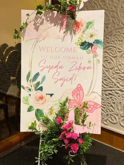 A dreamy butterfly-themed welcome sign for baby Zikra's Aqeeqah. We adorned the sign with fresh flowers and 3D butterflies to create a beautiful entrance piece.