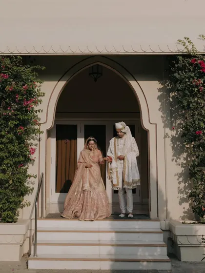 Apurva and Hemant framed in an arched doorway. This classic composition adds a sense of grandeur and timelessness to their wedding portrait.