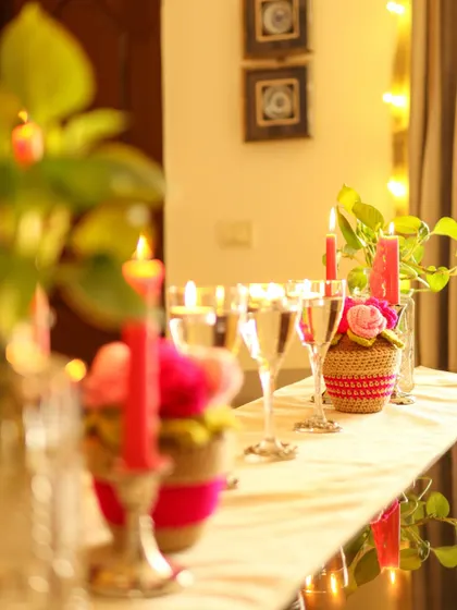 A long view of the tablescape, with multiple Rosie Posie arrangements and candles creating a beautiful, glowing runner.