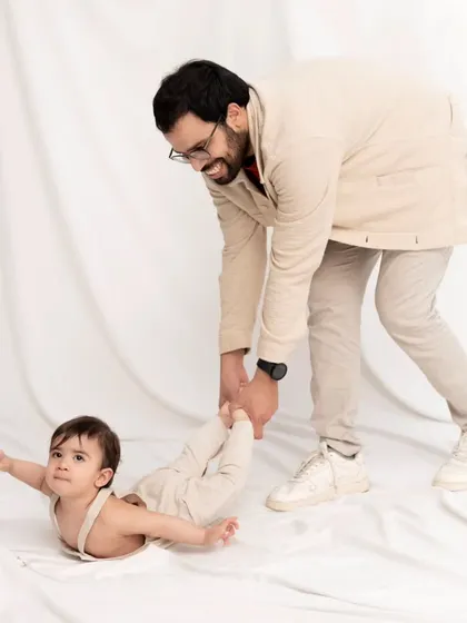 A playful moment between father and son. Sometimes the most memorable photos are the silly, unscripted ones, like this "flying baby" shot.