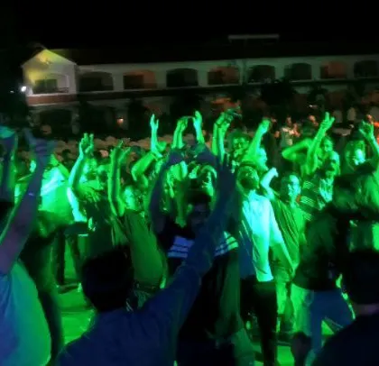 A corporate crowd with their hands in the air, bathed in green light. I love creating these high-energy moments that make any event unforgettable.