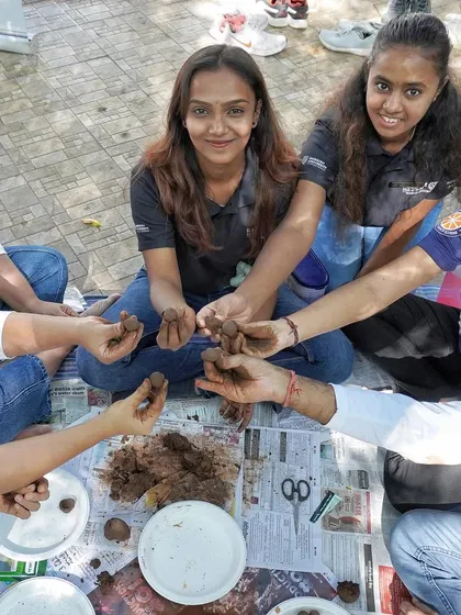 A group of students from Ramaiah University getting their hands dirty making seed balls. This is a fun, collaborative, and eco-friendly activity.