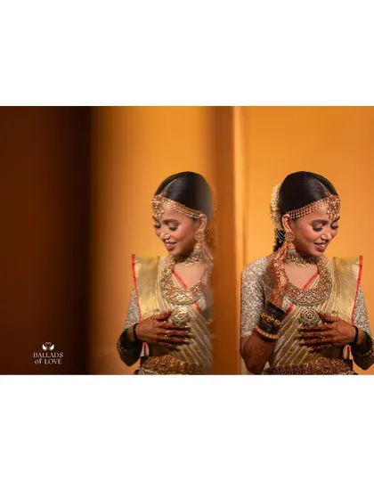 A creative shot of a bride's reflection. She is wearing a gold Kanchipuram saree with a custom fully embroidered blouse, looking radiant on her wedding day.
