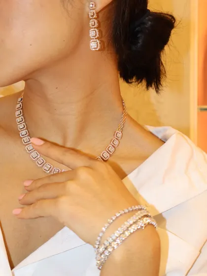 A full diamond set featuring a necklace, earrings, and a stack of three bracelets. Each piece is crafted to perfection and designed to be worn together for maximum impact.