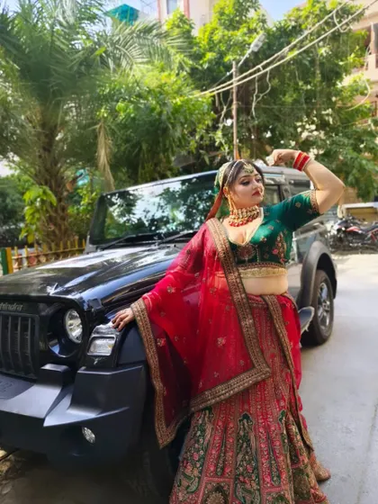 This bride looks absolutely regal in a red and green bridal lehenga. The combination is a classic for a reason, and the heavy embroidery adds a touch of royal elegance to her look.