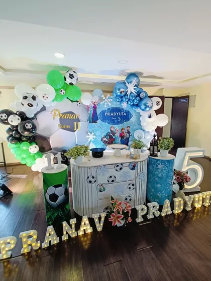 A wide shot showing the scale of the dual-themed party setup in the event space.