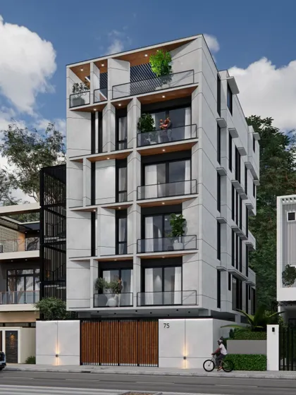 An angled view of the multi-family residence, highlighting the external staircase clad in a black metal screen, which adds a contrasting industrial element to the concrete structure.