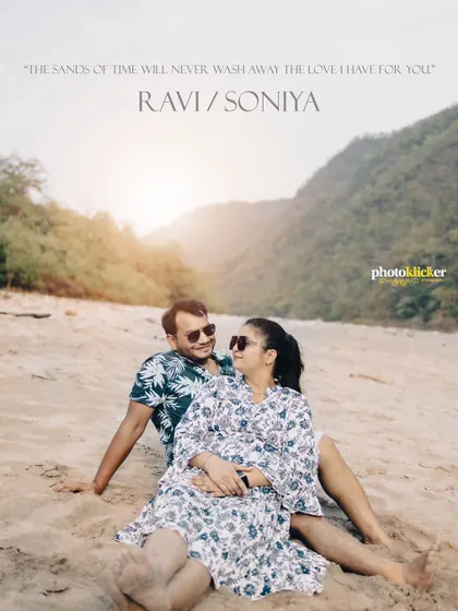A relaxed and romantic shot of a couple sitting on a sandy beach, capturing a quiet moment during their pre-wedding shoot.