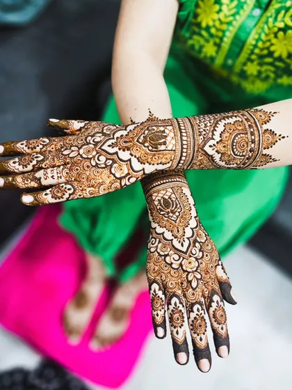 Here is another full bridal henna design, showcasing how the patterns flow from the palm all the way up the arm for a complete and traditional look.