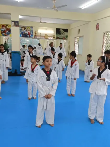 A group of white belts in their ready stance.