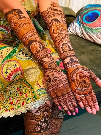 A stunning bridal design with peacocks on the palms and a variety of wedding scenes on the arms, including a doli and Ganesha.