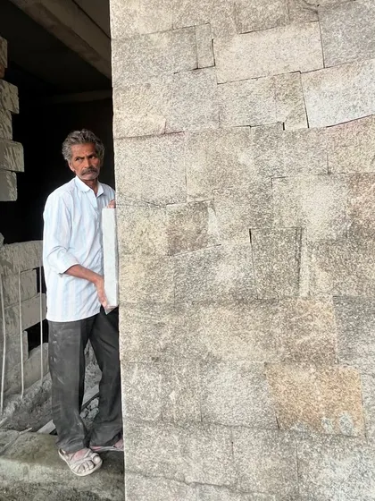 The master mason stands proudly by his work. We see craftsmen not just as laborers, but as essential collaborators in the architectural process, and we value their skill and knowledge.