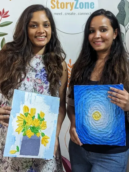 Two friends showing off their beautiful texture paintings, one of a vase of tulips and the other an abstract moonlit sky.