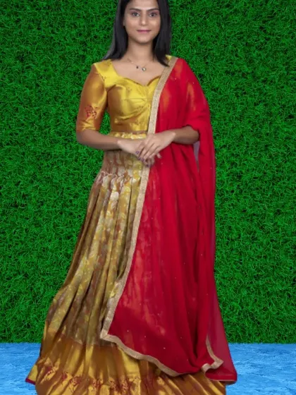 A classic ethnic look with this gold brocade lehenga paired with a bright red dupatta. This is a timeless choice for traditional events and photoshoots.