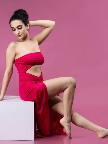 A different pose in the magenta dress, showing the model's graceful lines and the dress's movement.