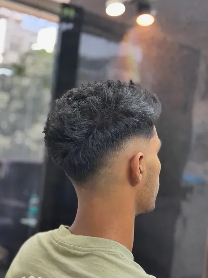 A clean taper fade from the back. Notice the smooth gradient from the neckline up, which is key to a professional-looking haircut.