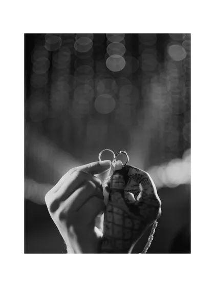 A creative black and white shot focusing on the engagement rings. I believe in capturing the details that symbolize your commitment, turning them into a piece of art.