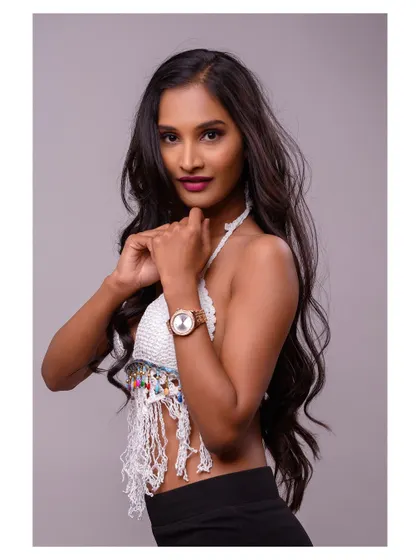 A studio portrait featuring a stylish crochet top. The focus is on the texture of the garment and the model's confident expression, making it a great shot for a fashion brand.