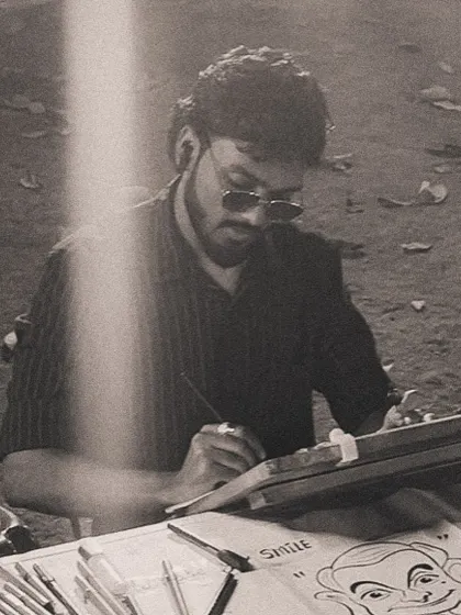 A black and white photo of me sketching, capturing the focus and passion I have for my art.