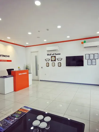 The main reception area, featuring a clean, minimalist design with the Tata Hitachi logo and a "Wall of Fame" for awards. This space sets a professional tone for visiting clients.