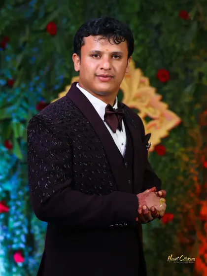 A classic portrait of the groom in a sharp three-piece suit, ready for the reception.