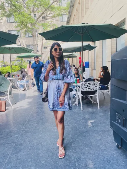 Walking through an outdoor cafe area in the blue dress. I help clients find versatile pieces that work for many different casual occasions.