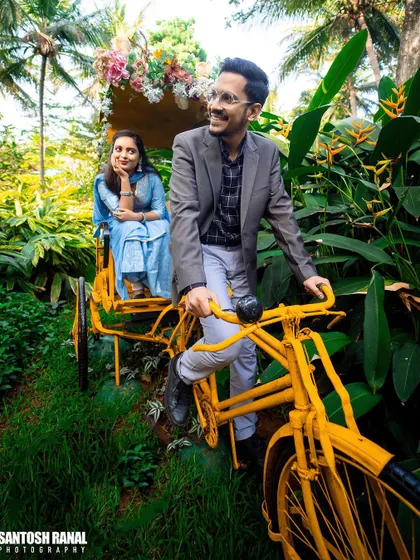A playful and charming photo of a couple on a yellow tandem bicycle.