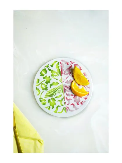 Another minimalist overhead shot, this time of a plate with a vibrant floral design, garnished with orange slices. This is great for a clean, modern aesthetic.
