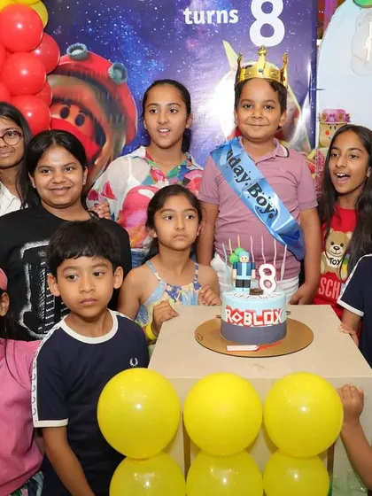 The birthday boy celebrates turning 8 with his friends and a Roblox-themed cake. Our themed parties ensure every detail, including the cake, matches your child's favorite game.